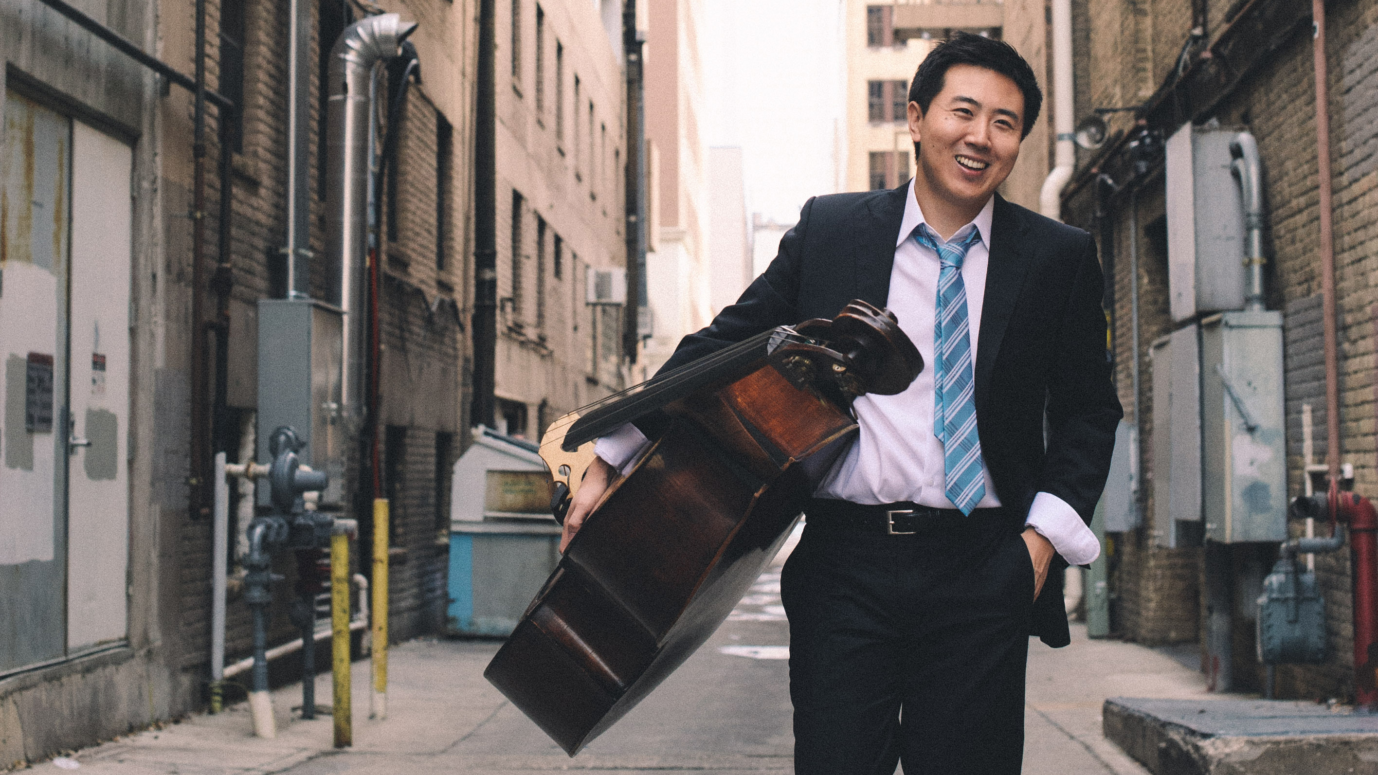 DaXun Zhang walking with his double bass