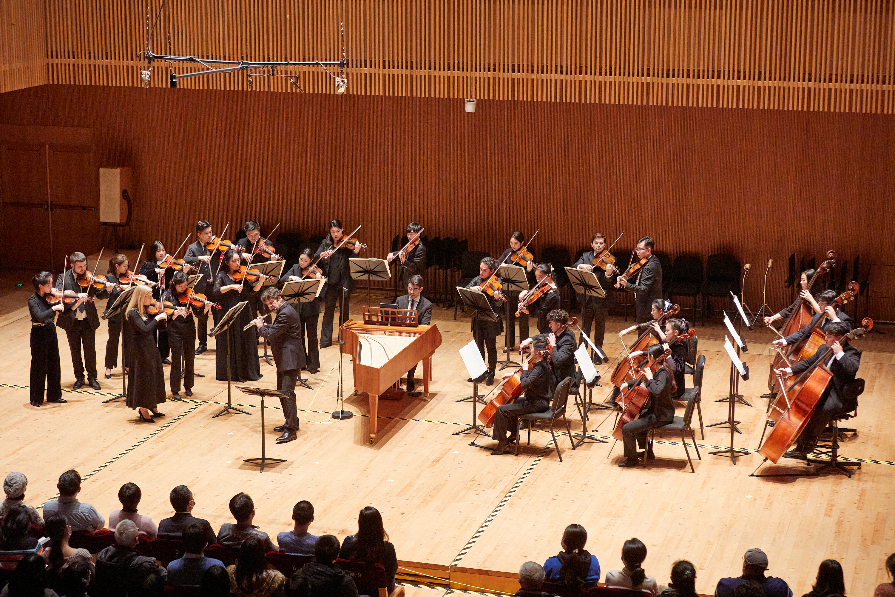 Tianjin Juilliard faculty alongside students performing Bach’s Orchestral Suite No. 2. 