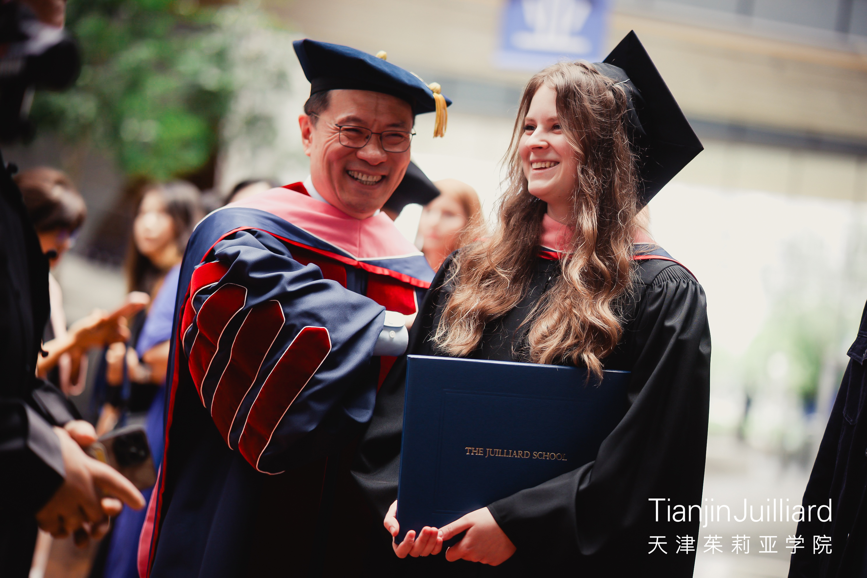 Wei He and Polina at Commencement in May 2026