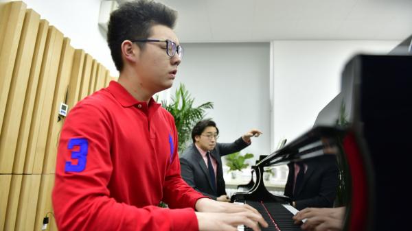 Alvin teaching piano
