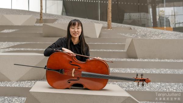 Sunny Jin posing for a portrait on Tianjin Juilliard's campus