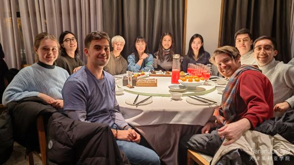 Viktoriya Klyukina, (MM ’24, flute), far left, having dinner at restaurant in Beijing.