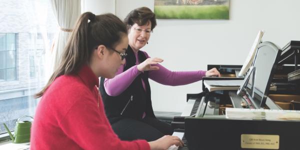 teacher and student at piano